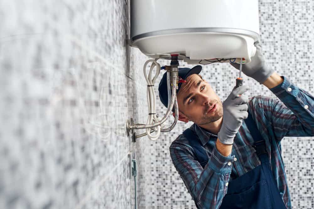 HVAC technician in New Jersey working on water heater