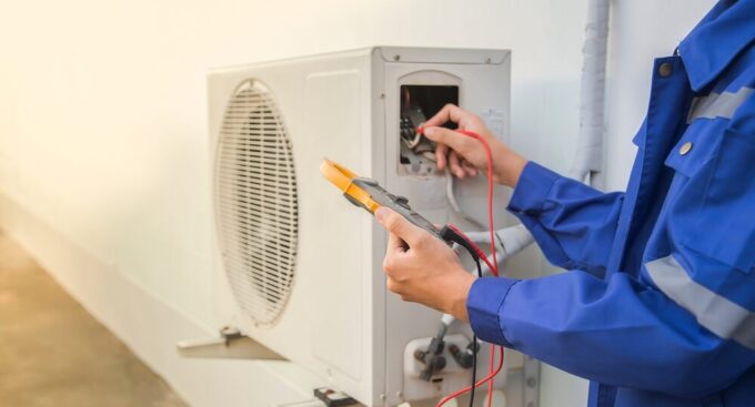 ac repair in New Jersey with technician running diagnostics