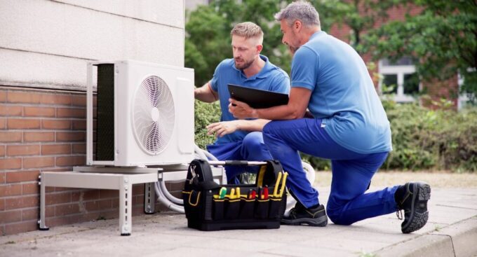 HVAC technicians working on a faulty unit in New Jersey